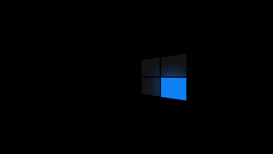 A close-up view of a stylized Windows logo with a blue accent against a black background