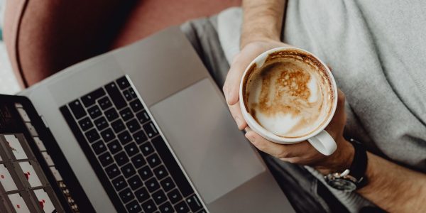 Coffee, cup, computer — Massage Nuru London Experiences Focused on Sensual Relaxation, Intimate Connection, and Therapeutic T
